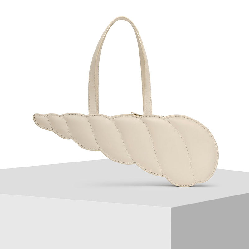 Elongated shell shape Cream Leather Tote Bag Designed by Nitya Arora