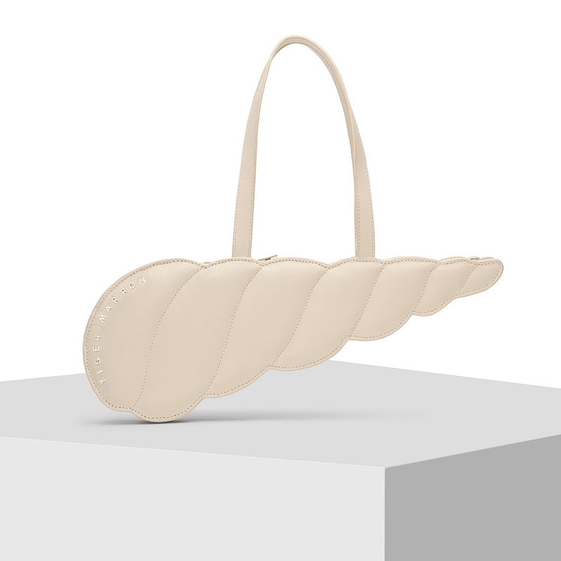 Elongated shell shape Cream Leather Tote Bag by Tiger Fish