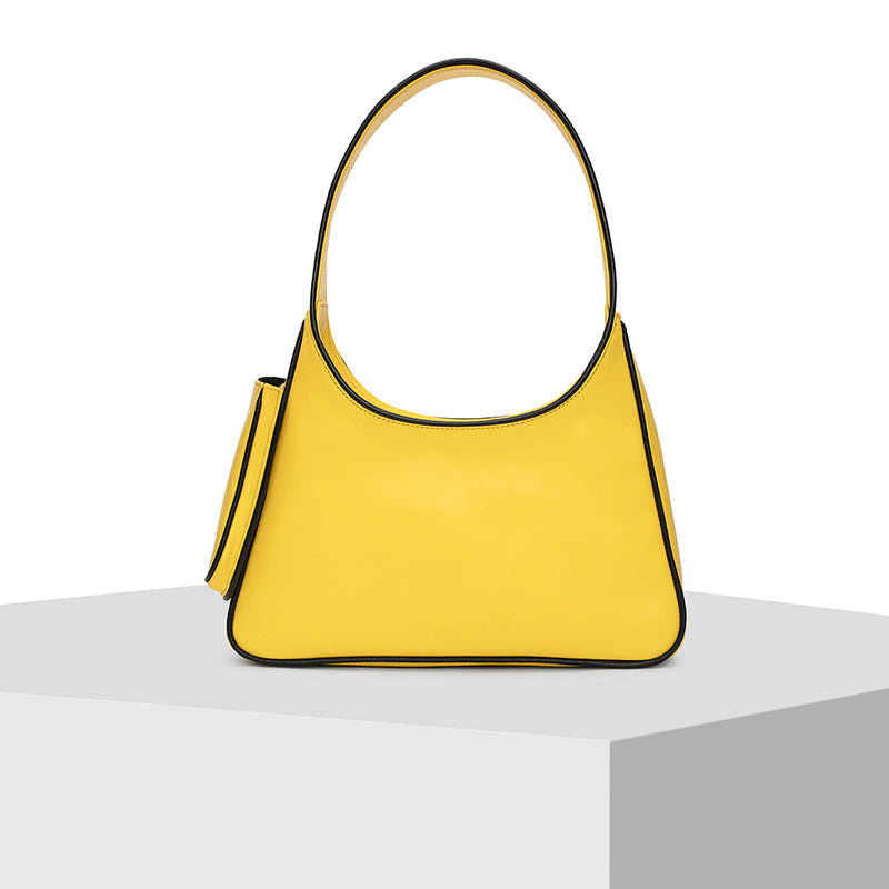 Yellow full grain leather bag by Nitya Arora